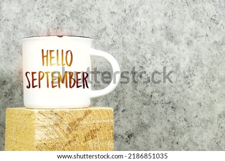 Hello September written on white coffee cup on 3d wooden cube Royalty-Free Stock Photo #2186851035