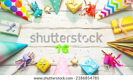 Beautiful colorful greeting card on the background of white boards happy birthday copy space. Beautiful ornaments and decorations festive background. Happy birthday number 16