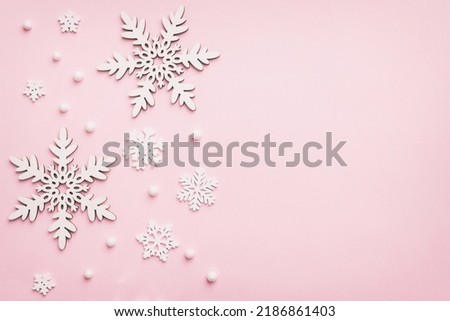 New Year composition white christmas snowflakes. Christmas decor background with pine cones. Top view with copy space.