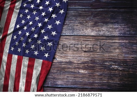 US flag on rustic wooden background for American Memorial Day, 4th of July Independence Day, or Labor Day concept.