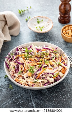 Asian cole slaw with creamy dressing, topped with salted roasted peanuts and green onion Royalty-Free Stock Photo #2186884001