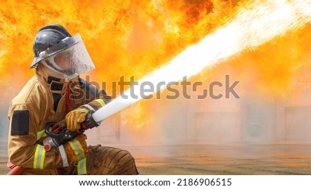 Fireman,Firefighter training Firefighters using water and fire extinguishers to fight the flames in emergency situations. in a dangerous situation All firefighters wear firefighter uniforms for safety Royalty-Free Stock Photo #2186906515