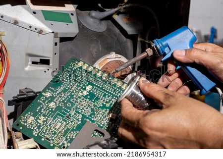 Close-up, TV repairman working in repair television and service shop