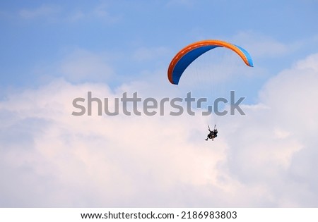 Paragliding in Interlaken, Switzerland. Interlaken is famous resort in paragliding flights. Royalty-Free Stock Photo #2186983803