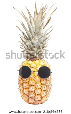 Pineapple wearing sunglasses. Summertime vacation holiday eating healthy concept.