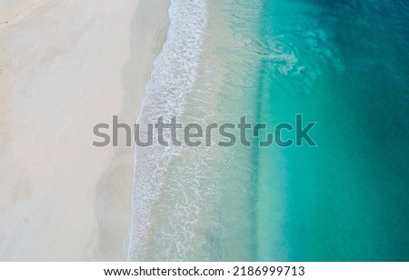 An aerial view of beach waves in slow motion Royalty-Free Stock Photo #2186999713