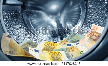 Money laundering. Many euro banknotes in washing machine Royalty-Free Stock Photo #2187028313
