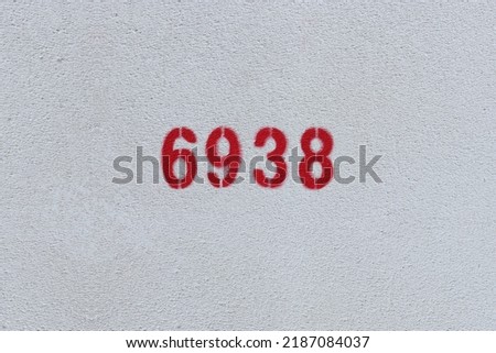 Red Number 6938 on the white wall. Spray paint.
