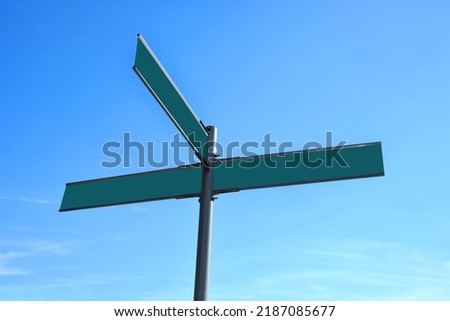 One and two empty street road signs on the opposite form an airplane symbol
