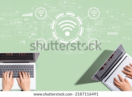 Wifi theme with people working together with laptop computers