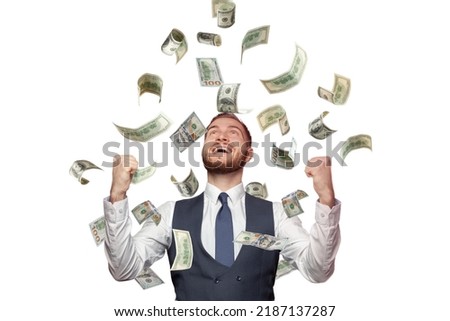 Happy successful man standing under money rain isolated on white background