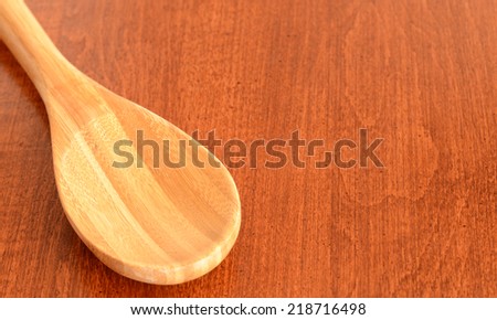 A close up of a wooden spoon on a table top