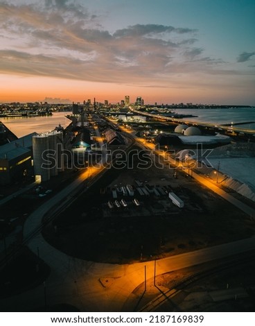 Industrial district with the Milwaukee skyline and hoan bridge in the background during a sunset.