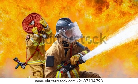 Fireman,Firefighter training Firefighters using water and fire extinguishers to fight the flames in emergency situations. in a dangerous situation All firefighters wear firefighter uniforms for safety