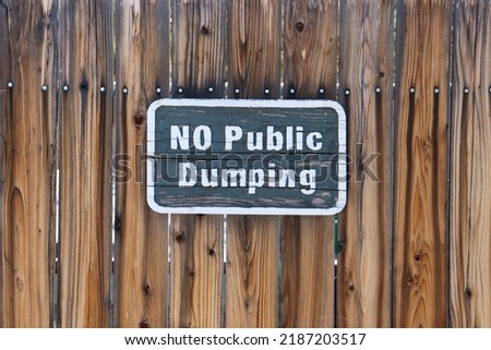 No Public Dumping Wooden Sign on Wooden gate.