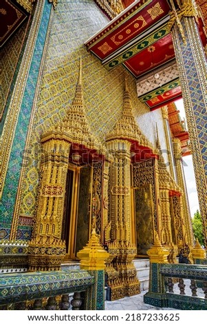 Beautiful exterior of the entrances into the main chapel of the Buddhist temple decorated with golden traditional Thai style pattern
