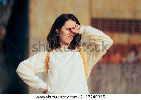 
Woman Covering Her Eyes from Strong Sun Shining in her Face. Unhealthy sunlight exposure for vision due to UV rays
 Royalty-Free Stock Photo #2187240315