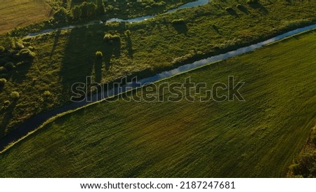 Rural landscape. Green forests and fields. River flows. Aerial photography.