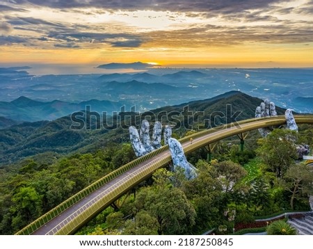 Aerial view of the Golden Bridge is lifted by two giant hands in the tourist resort on Ba Na Hill in Da Nang, Vietnam. Destinations for tourists from Thailand, Korea, America and Japan are relax Royalty-Free Stock Photo #2187250845