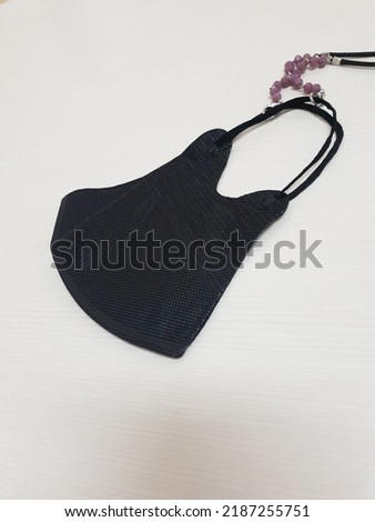 Black mask with fastening necklace