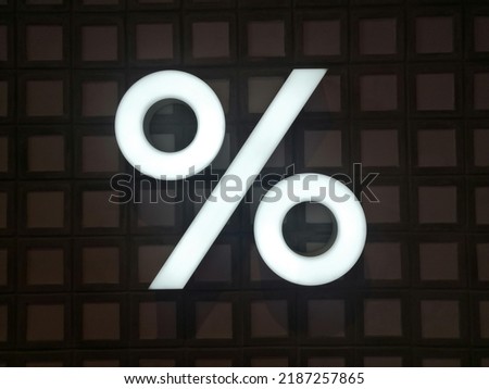 White lightbox text of percent icon in dark square backgroud