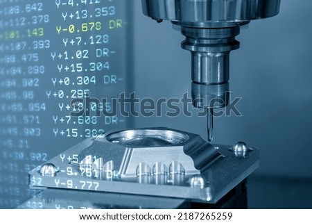 The abstract scene of CNC milling machine and the G-code data back ground with ball end mill tool. The mold parts cutting process by machining center. Royalty-Free Stock Photo #2187265259