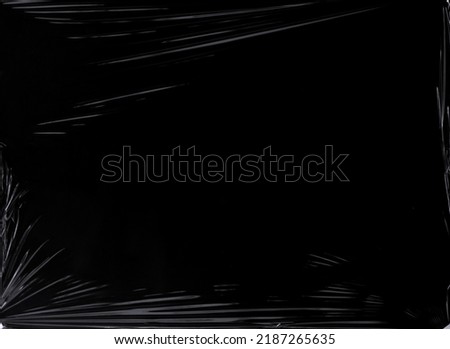 Black transparent plastic wrap texture overlay background. Realistic plastic for poster design and photo overlay effect. Wrinkled plastic surface pattern for graphic design sources and element. Royalty-Free Stock Photo #2187265635