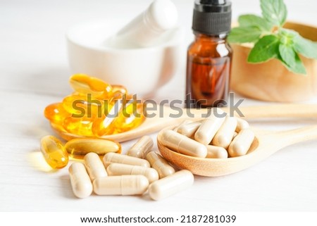 Alternative medicine herbal organic capsule with vitamin E omega 3 fish oil, mineral, drug with herbs leaf natural supplements for healthy good life. Royalty-Free Stock Photo #2187281039