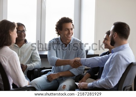 Team of multi ethnic businesspeople finish business training or formal meeting in office with shake hand. Psychological counselling group event end, express respect, make recognition gesture concept Royalty-Free Stock Photo #2187281929