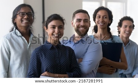 Multi racial company members, enthusiastic business people smile pose in office. Professional advisory, accounting department, group of successful employees portrait, teamwork, racial equality Royalty-Free Stock Photo #2187281991