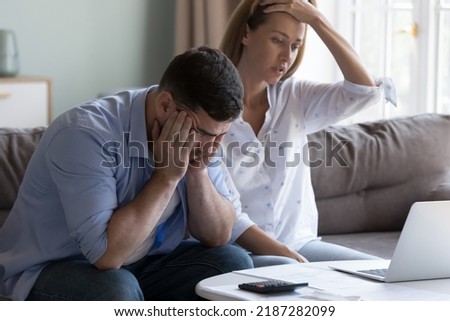 Stressed spouses manage family finances, analyze expenses, check savings and budget, looks disappointed due to mortgage arrears, unpaid utility bills, debt notice. Lack of money, high utility Royalty-Free Stock Photo #2187282099