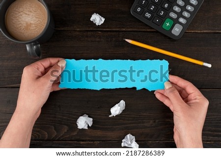 Hands Of Woman With Pastel Color Paper, Coffee Cup And Stationery Over Wooden Background. Businesswoman Holding Sheet With Copy Space Displaying Business Branding.