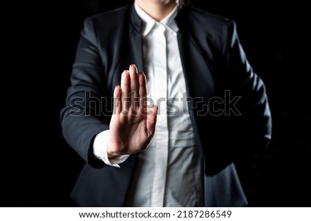 Businesswoman Presenting Important Message Next To Hand. Woman In Suit Showing New Crutial Idea With Palm. Executive Displaying Updated Critical Information.