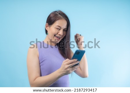 Asian woman was surprised and excited about the smartphone.