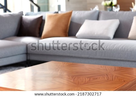 Close-up of bright living room with sofa and table in front of sofa against blurred background Royalty-Free Stock Photo #2187302717