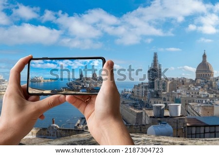 Tourists taking photos of Valletta harbor with Valletta old town and Sliema, Valletta, Malta.