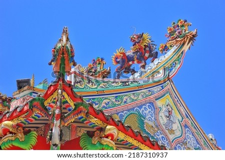 The lion's body resembles a tiger. dragon-like head On the roof of a Chinese shrine in Thailand