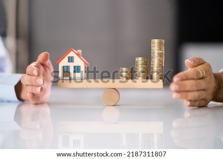 House Model Balance Equilibrium Concept. Real Estate Money Royalty-Free Stock Photo #2187311807
