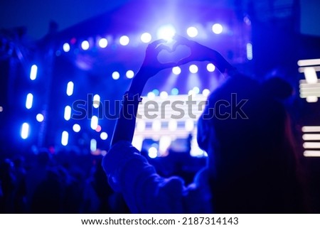 Сrowd with raised hands at music festival. Summer holiday, vacation concept.
