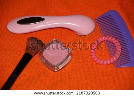 Various facial care gadgets, comb and blush