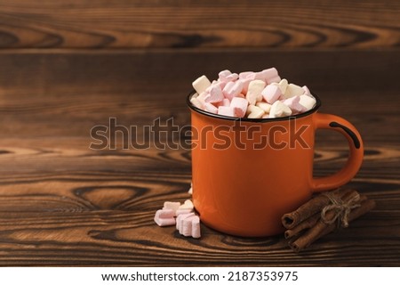 Cocoa drink on texture background. Hot chocolate with small marshmallows and spices. Winter warming drink concept. Space for copy. Space for text