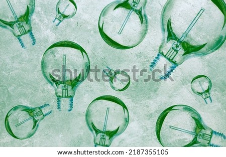 Lightbulbs in a green color grid - stock photo