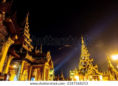 Lens Flare in the picture of group of golden pagodas and mondops are illuminated in the light of the night Royalty-Free Stock Photo #2187368253