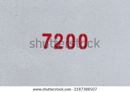 Red Number 7200 on the white wall. Spray paint.
