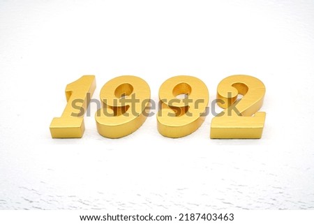   Number 1992 is made of gold painted teak, 1 cm thick, laid on a white painted aerated brick floor, visualized in 3D.                                