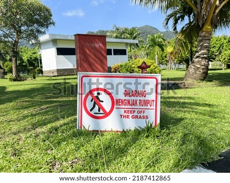 White Sign “Keep off the Grass” placed on a grass background