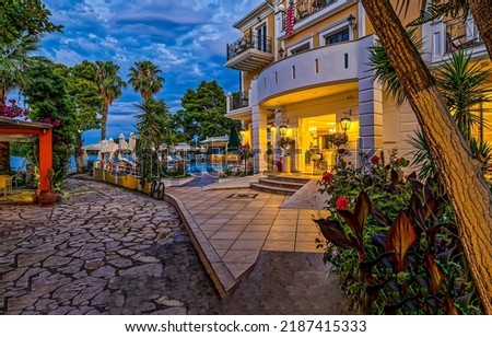 Entrance to the resort hotel by the sea in the evening. Resort hotel with swimming pool. Resort hotel entrance. Resort hotel in evening Royalty-Free Stock Photo #2187415333