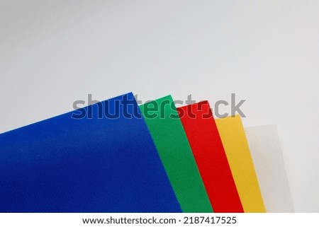 Set of colorful backgrounds for photos. Stack of multi-colored fabrics. Set of colorful sheets of paper.