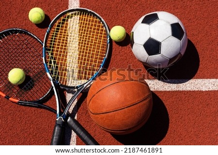 A group of sports equipment on black background including tennis, basketball, and soccer and boxing equipment on a background with copy space Royalty-Free Stock Photo #2187461891