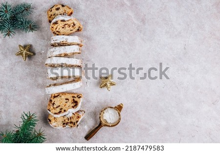 Traditional Christmass stollen on stone background. Top view with copy space
